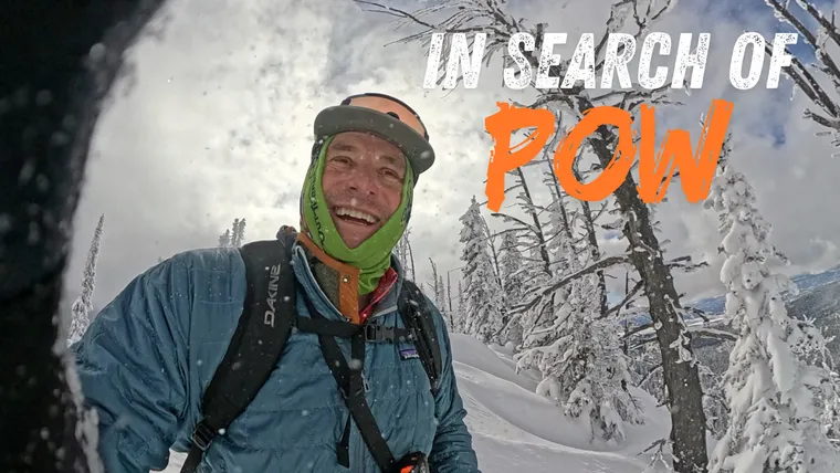 Picture of man in front of snow covered trees. 